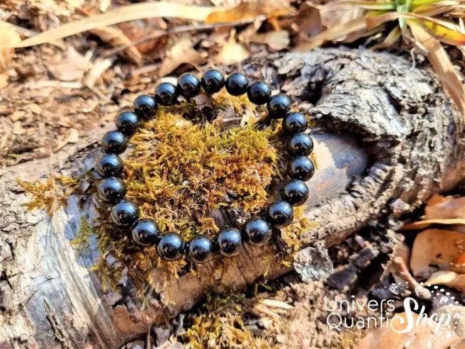 spinelle noire bracelet pierre naturelle 8mm qualité A sur une branche d'arbre dans la forêt